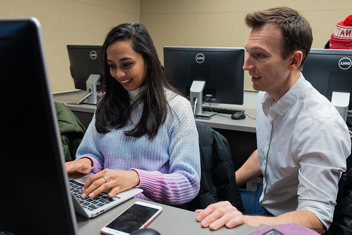 Professor Robbie Beane in class with a student